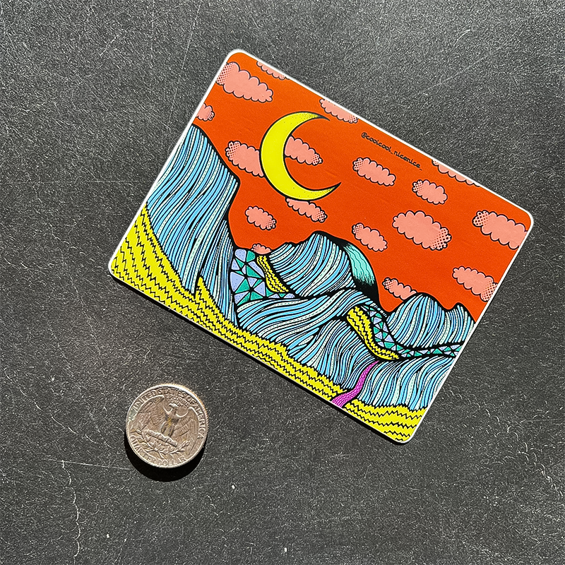 A coin beside a weather-resistant Half Dome sticker.