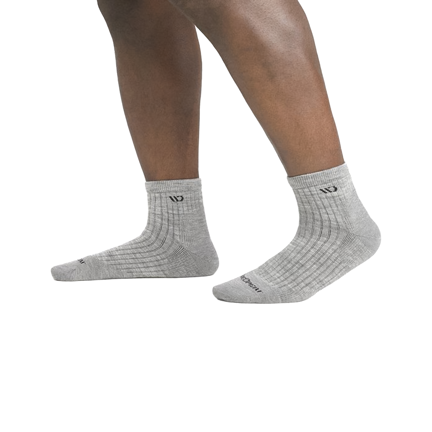 Close-up of legs in grey quarter socks highlighting their midweight Merino wool and plush cushioning with Wide Open logo.
