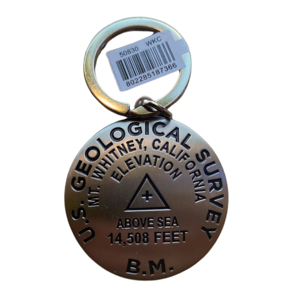 Metal keychain with U.S. Geological Survey information on a white background