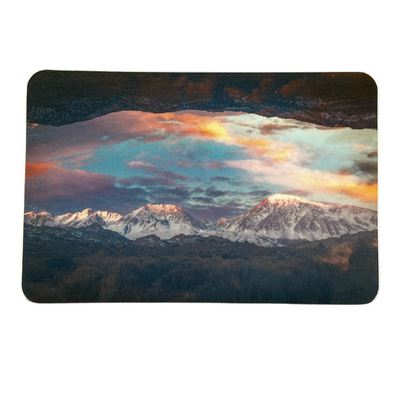 A scenic mountain view with vibrant clouds and snow-covered peaks.