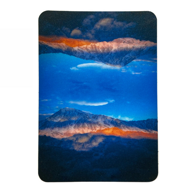 A picturesque mountain landscape in blue and orange hues.
