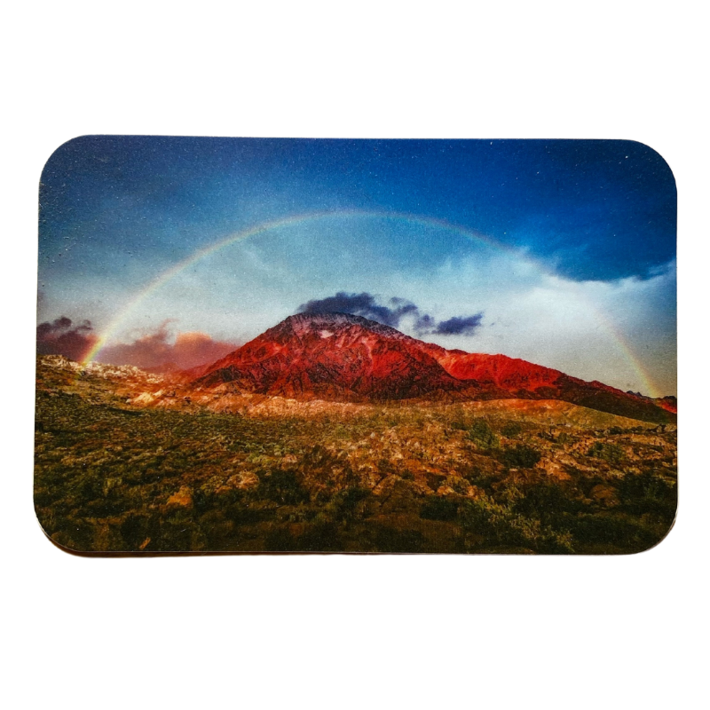 A vibrant rainbow arching over a majestic mountain, with another rainbow painted across the sky.