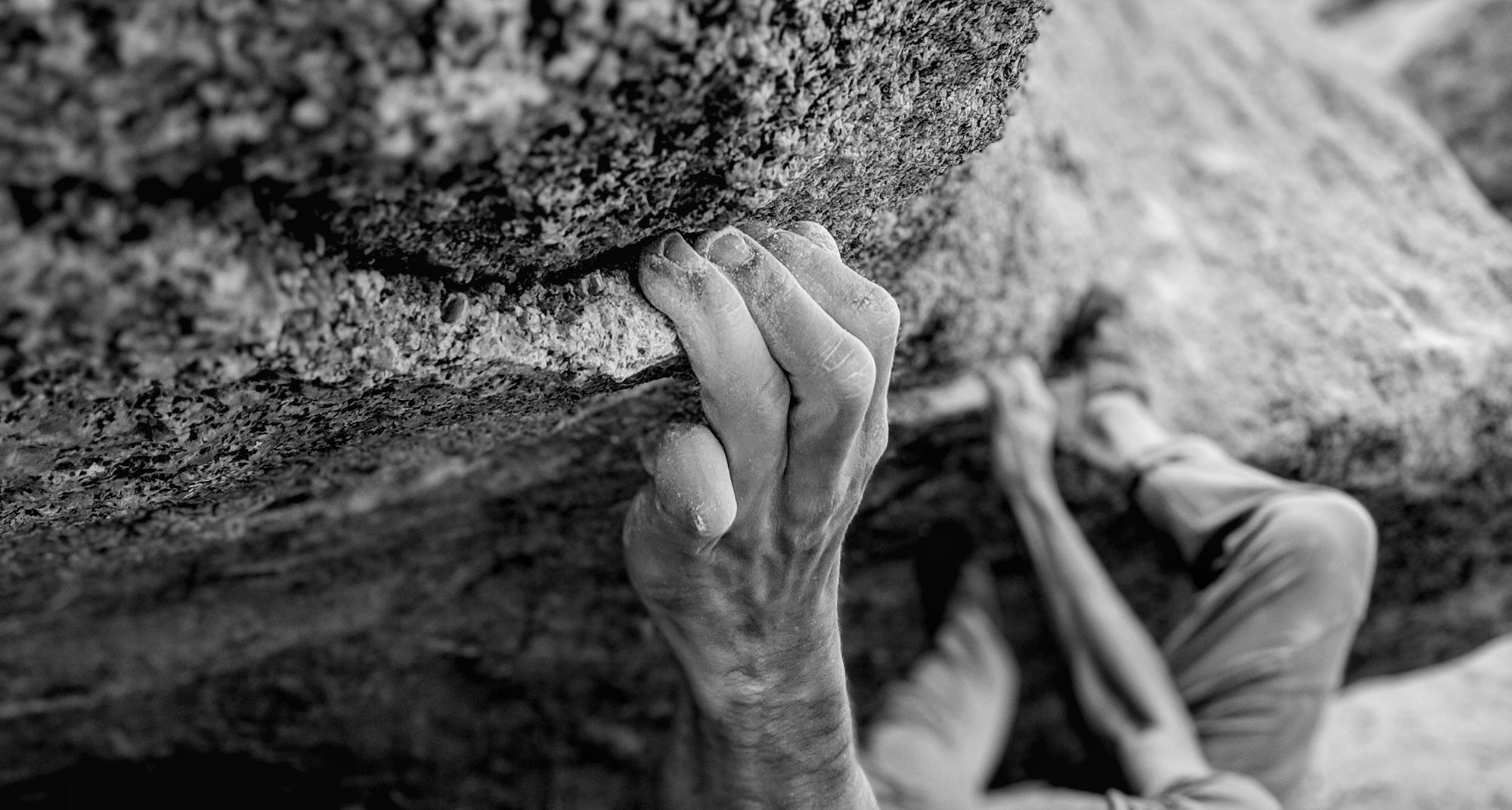 close up of fingers pulling on a granite crimp