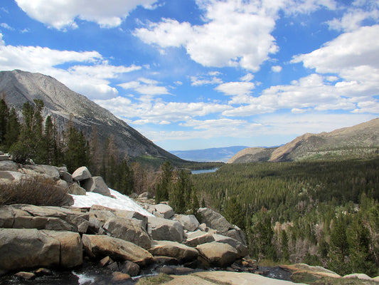 Mountain scape with snow trees and clouds