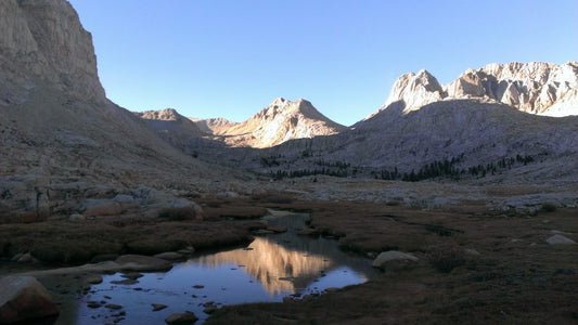 Mountain scape with lake trees and clouds