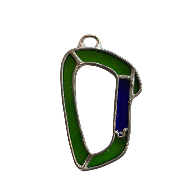 Green and blue metal object on a white paper background