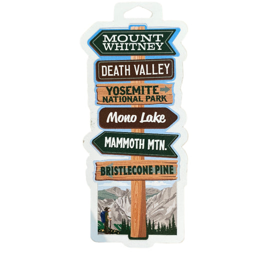 A sticker with various mountain and national park names on a signpost