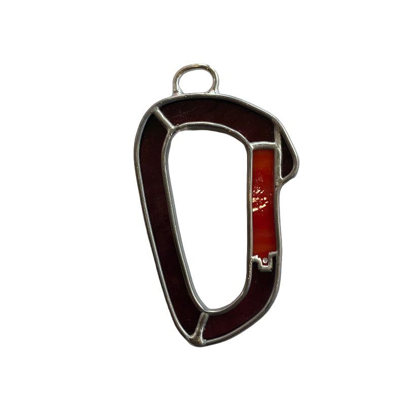 Metallic carabiner on a white sheet of paper