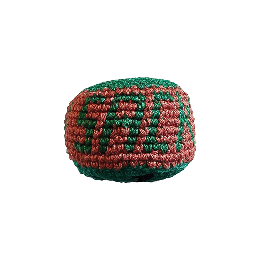 A green and red ball labeled "SACK", representing the Adventure Trading Inc. Squatch Footbag.