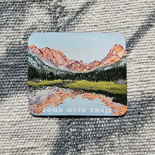 A colorful magnet showcasing a stunning mountain landscape, ideal for decorating and celebrating nature's beauty.
