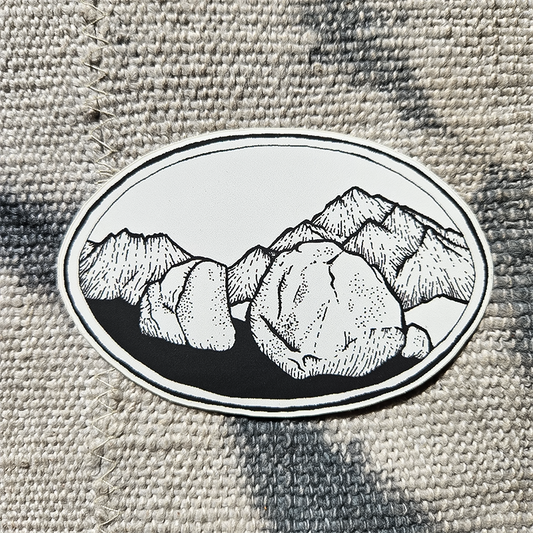 Mountain scene sticker with a rock, designed for climbers, showcasing Peabody Boulders' rugged outdoor spirit.