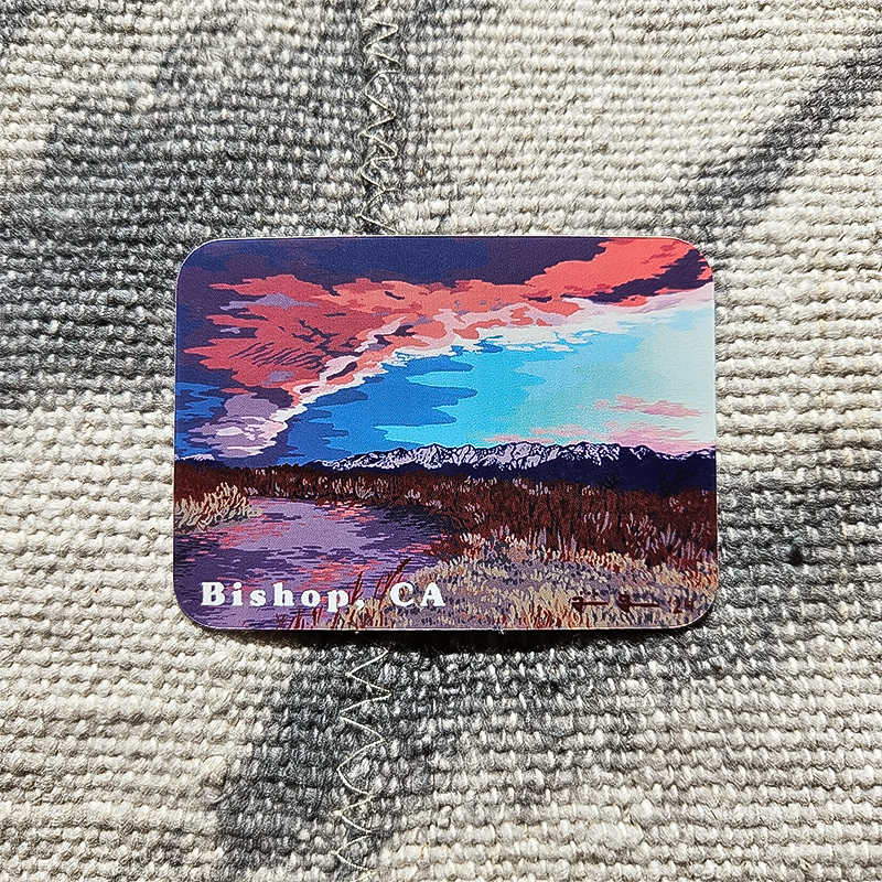 A colorful sticker depicting mountains and clouds, ideal for adding a nature-inspired touch to laptops and water bottles.