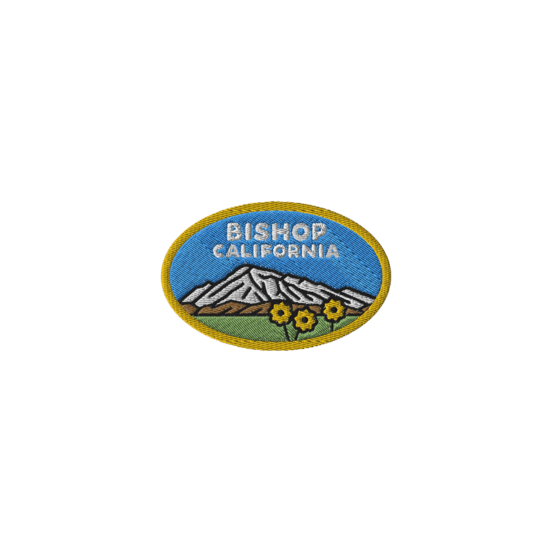 Souvenir patch featuring "Bishop California," white mountains, and flowers in an oval shape.