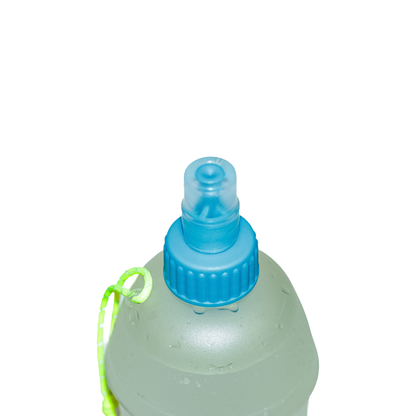 Hydration bottle in green with a blue lid and bite valve, perfect for on-the-go drinking during outdoor excursions.