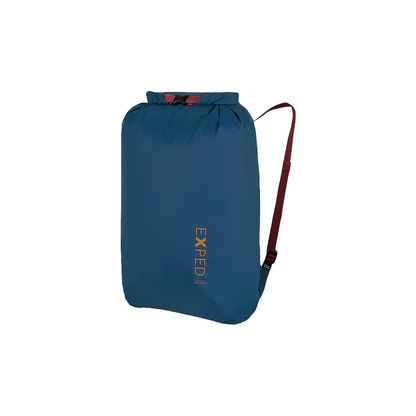 Blue roll-top dry bag with red handle and shoulder straps, perfect for portaging and compact travel storage.