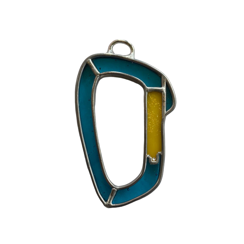 Metallic keychain with blue and yellow design on a white paper background