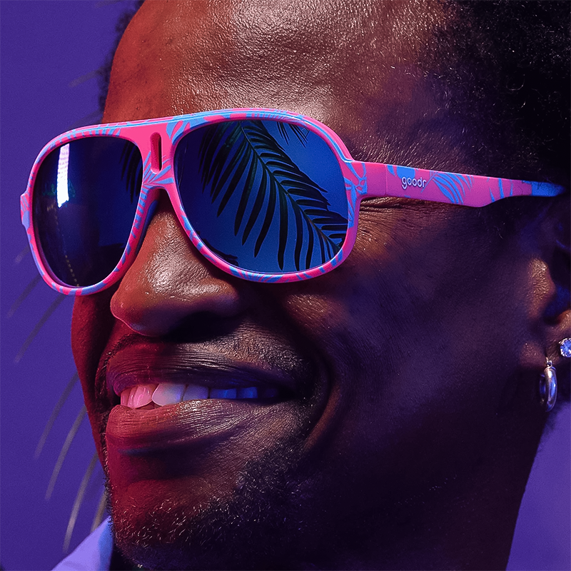 A man in Goodr Super Fly sunglasses, featuring a stylish retro design for active lifestyles.