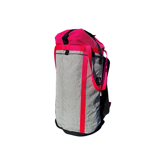 Pink and grey haul bag with a pink strap, designed for climbers, featuring durable, lightweight materials for outdoor adventures.