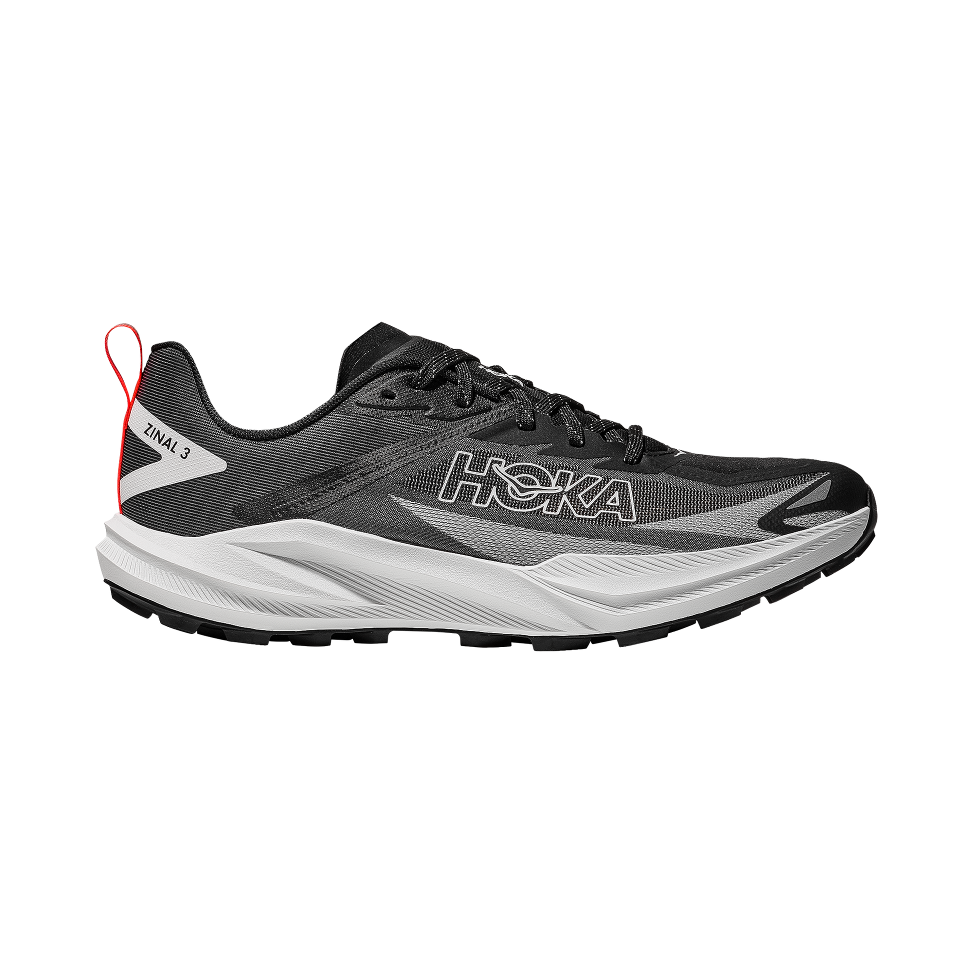 Black and white Hoka Zinal 3 trail running shoes on a rocky path, showcasing their lightweight design and aggressive lugs for traction.