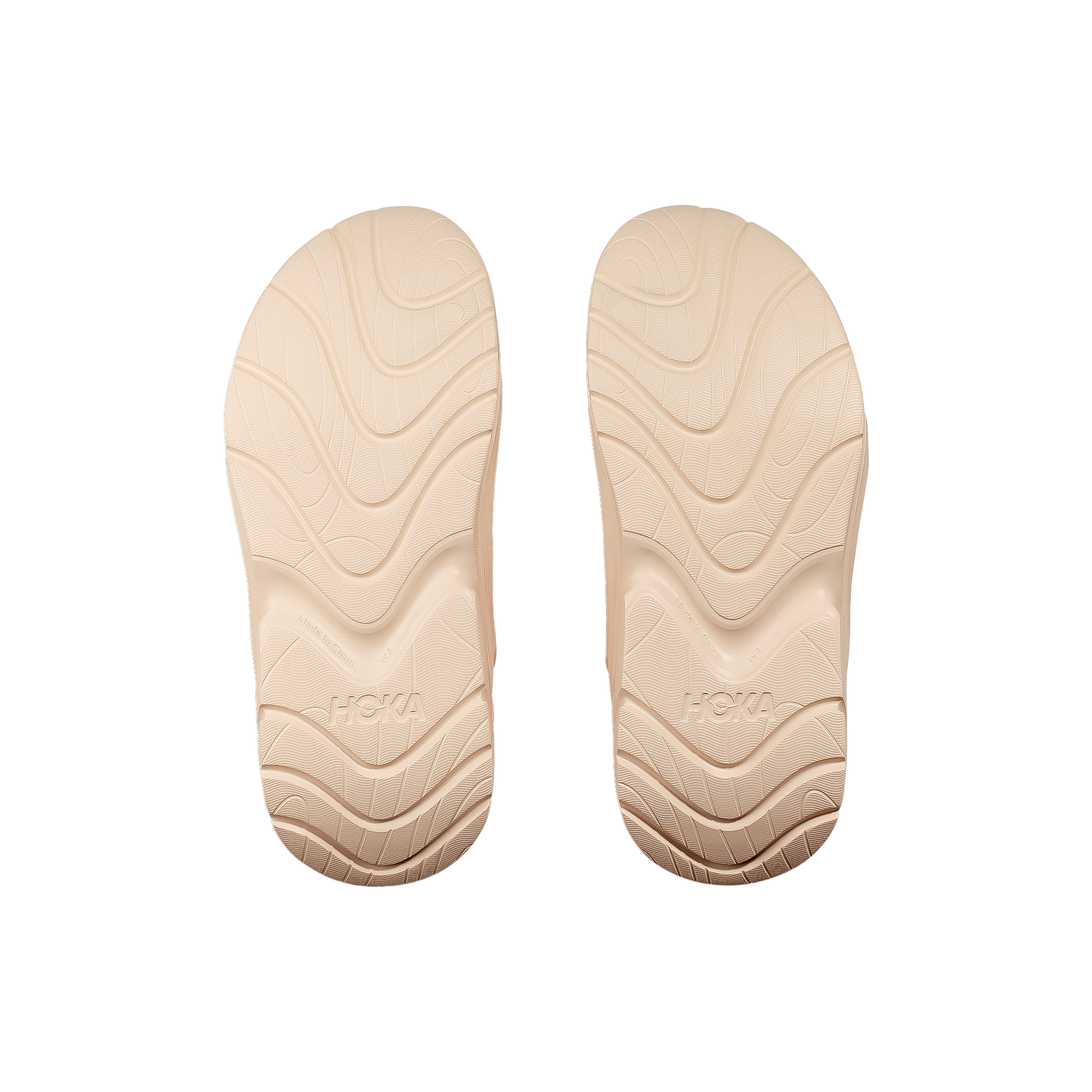 Sole of beige Hoka Ora Recovery Mule sandals featuring a wave pattern, designed for comfort and post-activity relaxation.