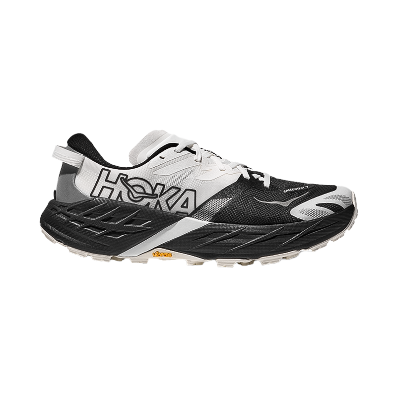 Hoka women's Speedgoat 7 trail running shoes in black and white with max cushioning, Vibram outsole, and lightweight upper for technical terrain performance.