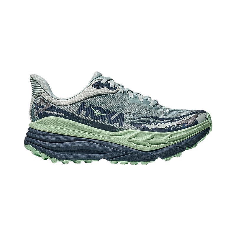 Hoka One One women's green Stinson 7 shoes, designed for all-terrain adventures with cushioning and grip.