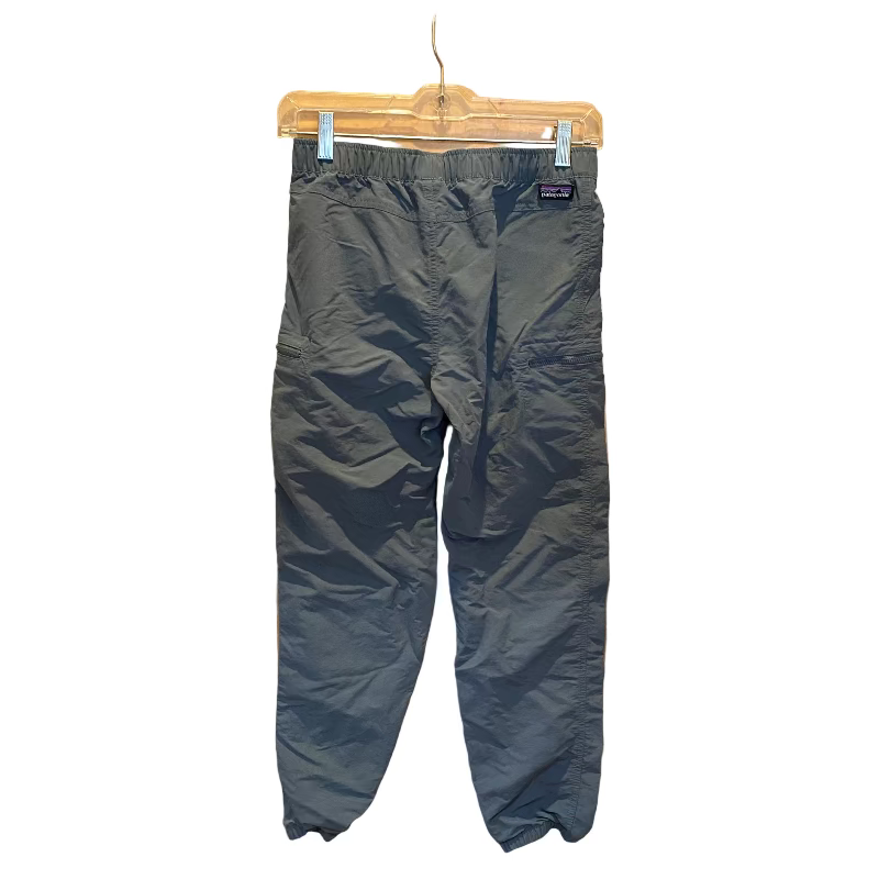 Dark blue pants hanging on a wooden door