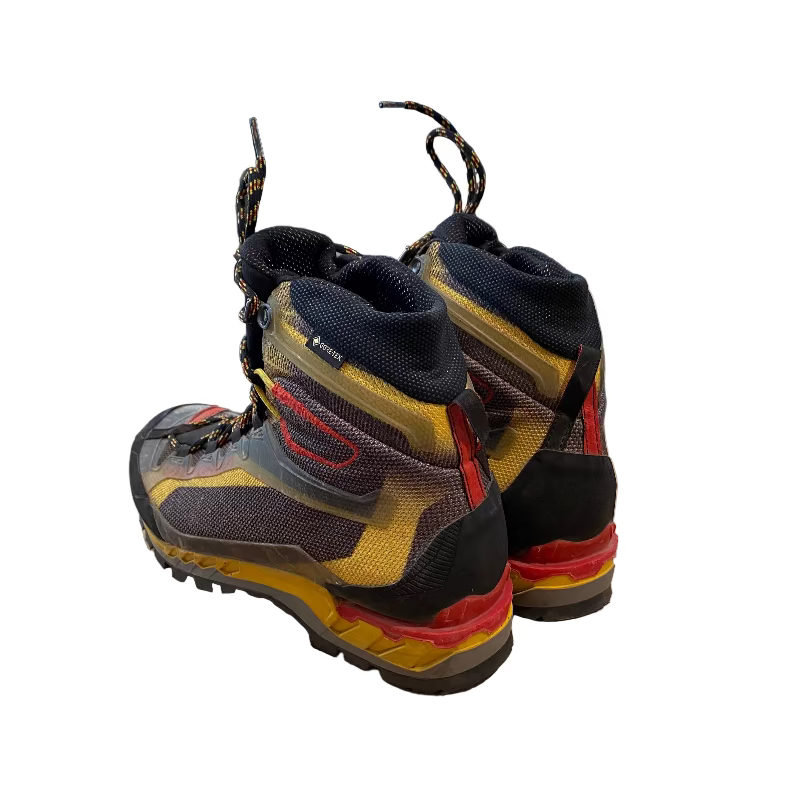 Pair of colorful boots on a wooden floor with a store interior in the background