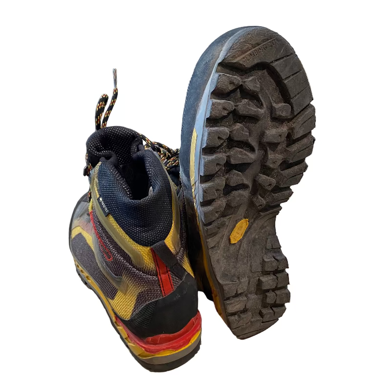 Pair of hiking boots with a focus on the sole in a store setting