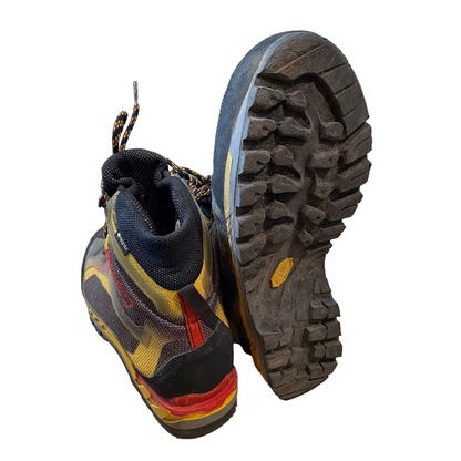 Pair of hiking boots with a focus on the sole in a store setting
