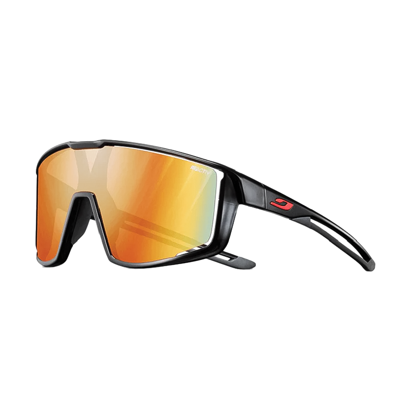 julbo fury Sunglasses with reactiv 1-3 light amplifier reflective lenses and translucent black frame on a white background
