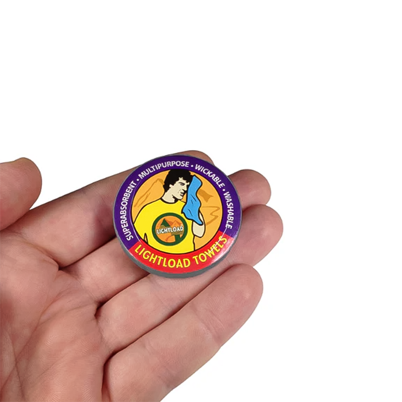 Round container featuring a cartoon character, with an ultra-compact towel for travel.