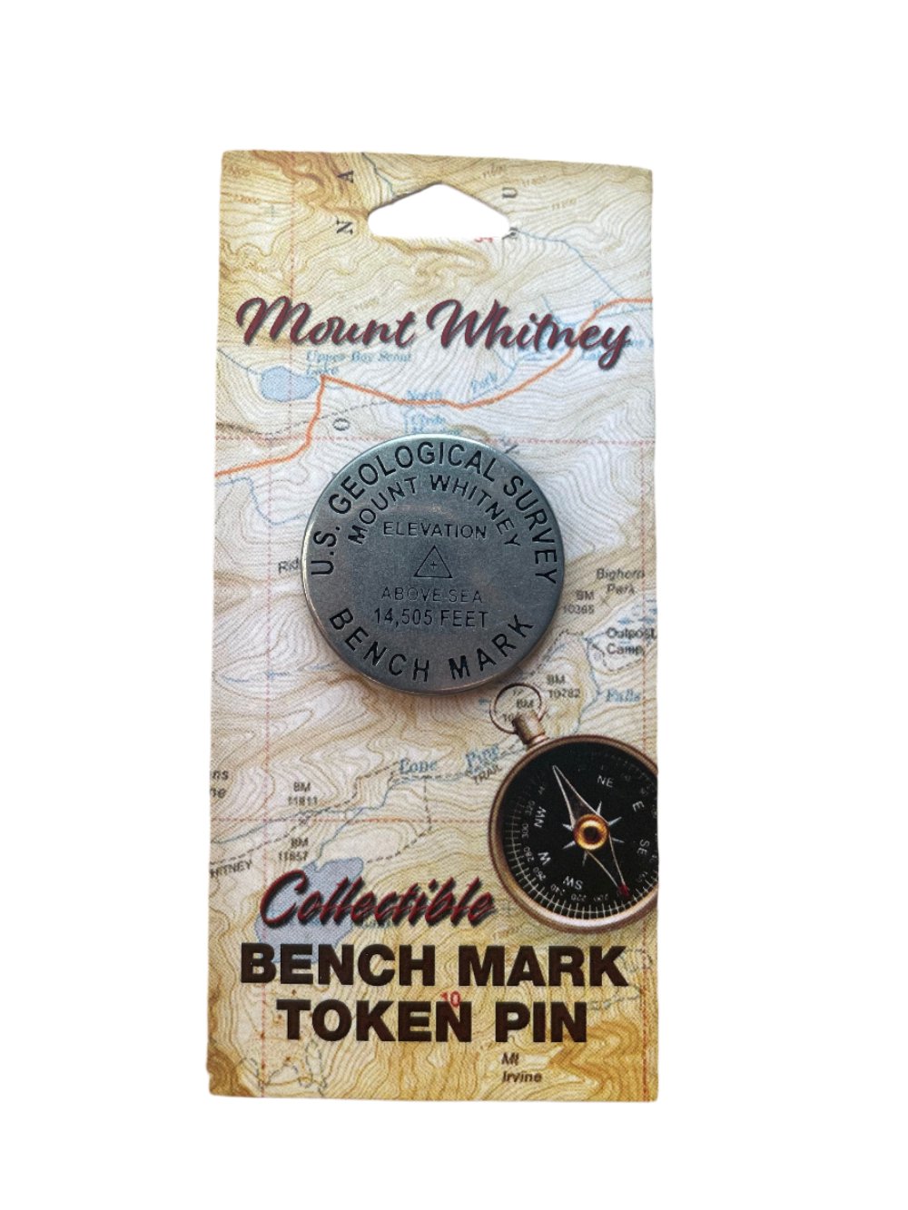 A silver pin in the shape of a benchmark disc for Mount Whitney.