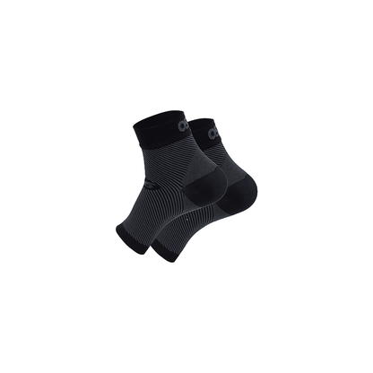A pair of black foot sleeve laid flat on a white background, showcasing their simple design and color.