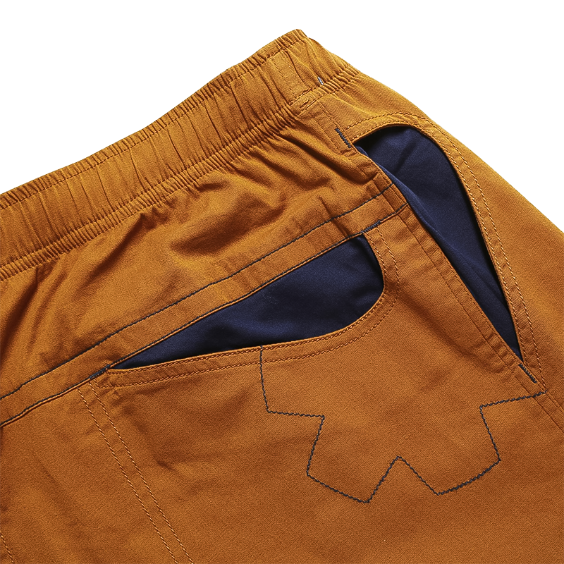 Breathable light brown 3/4 climbing pants with three pockets, brush loops, and elastic waistband.