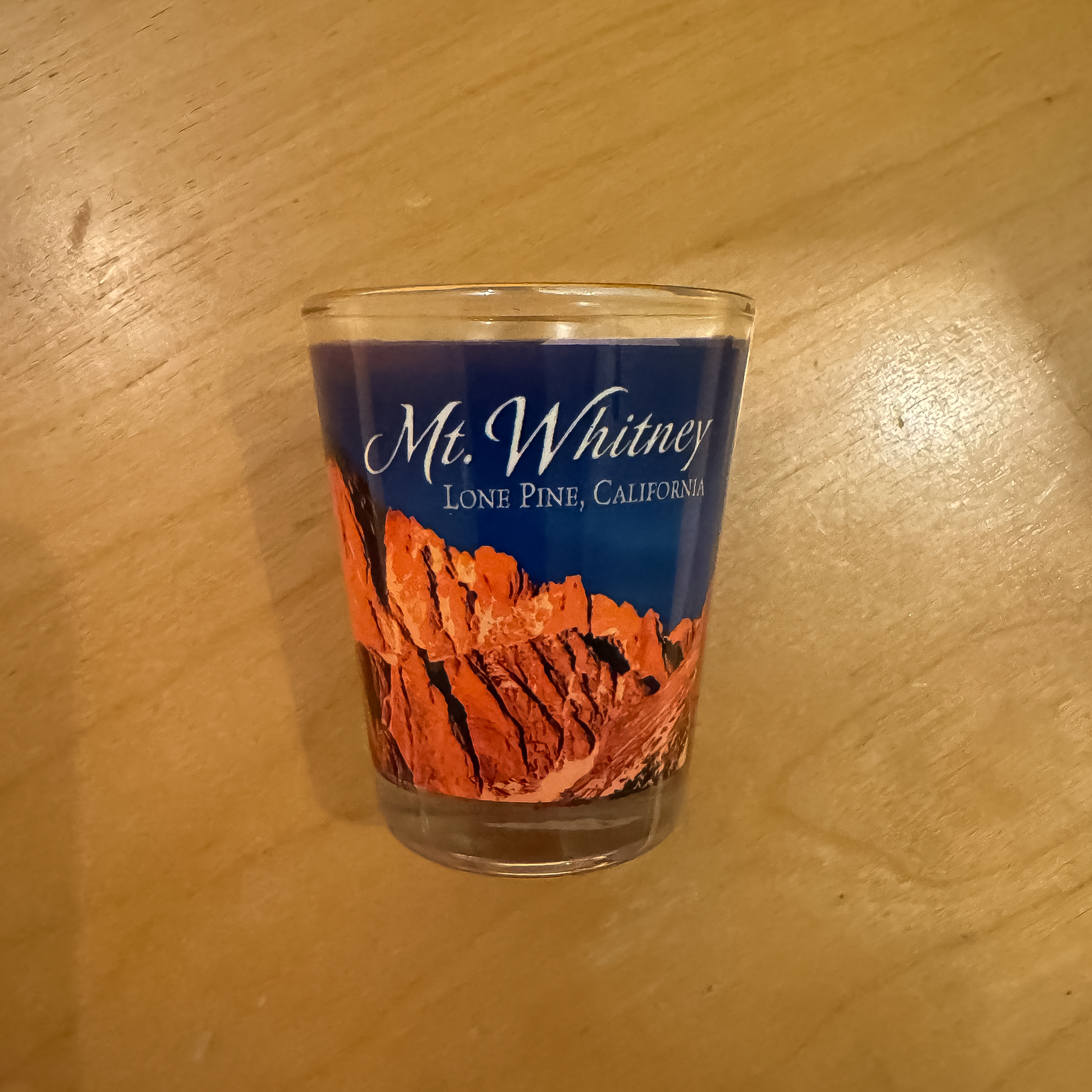 Shot glass featuring "Mt. Whitney" text, showcasing Mount Whitney's elevation and scenic mountain artwork.