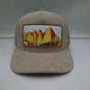 Mt. Whitney Khaki Corduroy Trucker HatA khaki trucker hat made of corduroy fabric with a mesh back, featuring a curved brim and a plastic snapback closure
