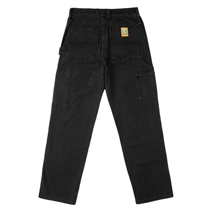 Black utility jeans with a yellow label, featuring reinforced knees and multiple pockets for functionality and style.