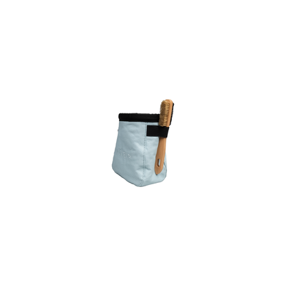 Light blue climbing chalk bag with a wooden brush, showcasing a fleece-lined interior and adjustable belt for comfort and convenience.