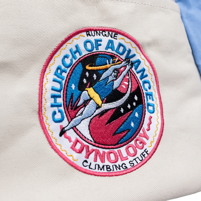White, blue, and gray chalk bucket featuring the Church of Advanced Dyno logo, designed for bouldering with a stable, self-standing structure.