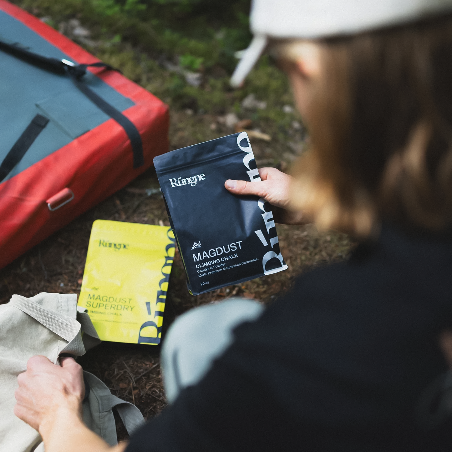A woman sits on the ground holding the Rungne Magdust Chalk.