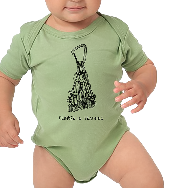 Baby dressed in a green bodysuit with a climbing equipment print with climbing in training, showcasing future potential.
