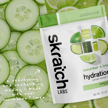 Skratch Labs cucumber and lime hydration drink mix package on a background of sliced cucumbers and limes.