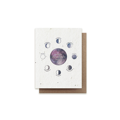 A birthday card featuring a purple and pink moon illustration with the moon phases, printed on plantable seeded paper.