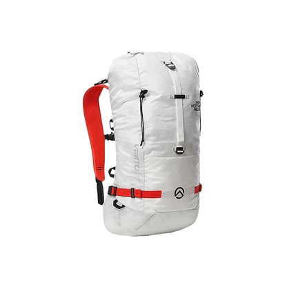 North Face white verto 27 backpack with red straps, perfect for alpine climbing, featuring durable fabric and a coiled rope stash under the lid.