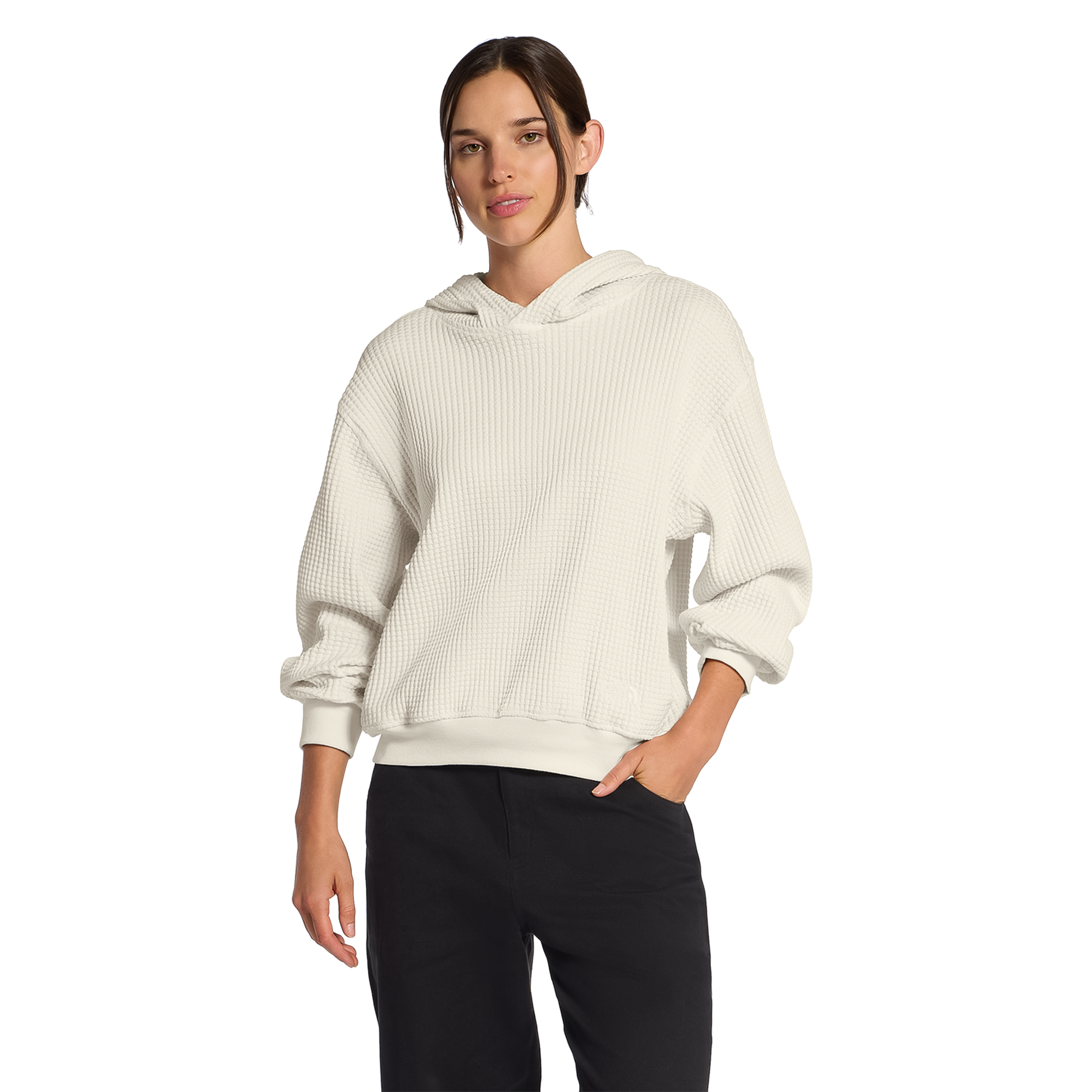 A woman wearing a cream Chabot 2.0 Hoodie in soft cotton, featuring a relaxed fit, two-piece hood, and open hand pockets for comfort.