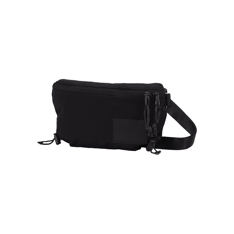 Black North Face waist bag with front zipper, made from recycled nylon, for urban and outdoor use.