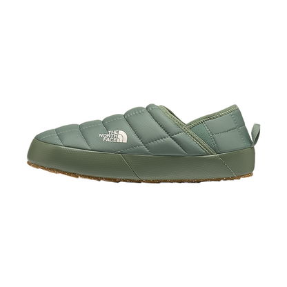 Green women's slippers by The North Face with insulated upper, cozy lining, and recycled rubber outsole.