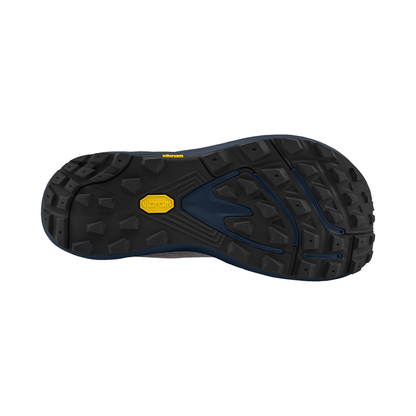 Detailed view of a black and navy shoe sole, designed for trail running with superior traction and natural foot movement.