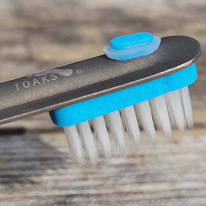 A lightweight blue-capped toothbrush for hikers that attaches to utensils.  